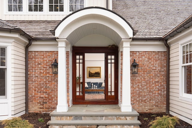 doorway to property with brick siding