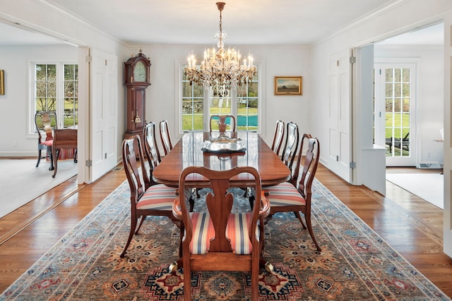 dining space with ornamental molding and wood finished floors