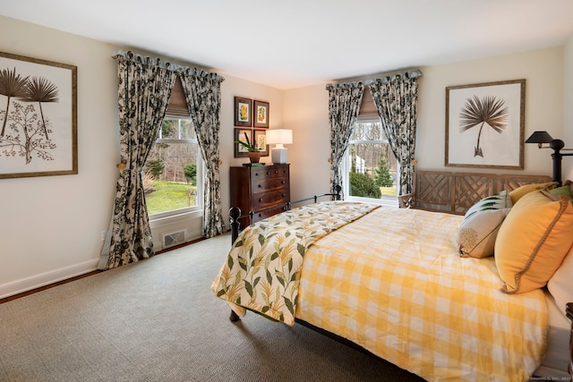 bedroom featuring carpet, baseboards, multiple windows, and visible vents