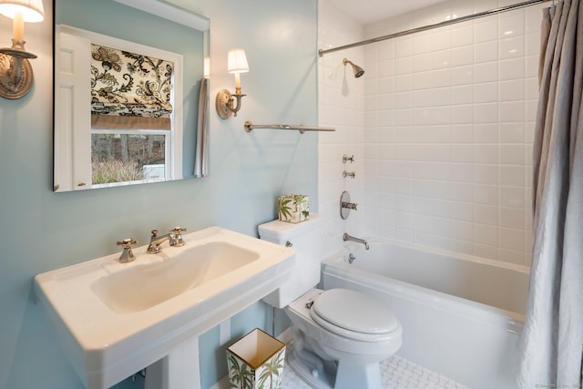 bathroom featuring shower / tub combo, a sink, and toilet