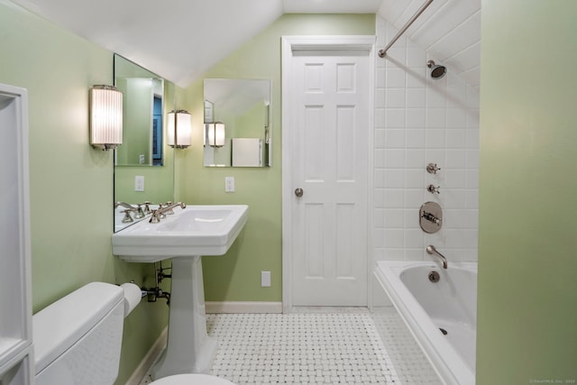 bathroom with lofted ceiling, shower / bathing tub combination, toilet, baseboards, and tile patterned floors