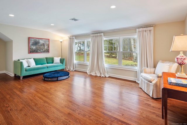 sitting room with recessed lighting, visible vents, vaulted ceiling, wood finished floors, and baseboards