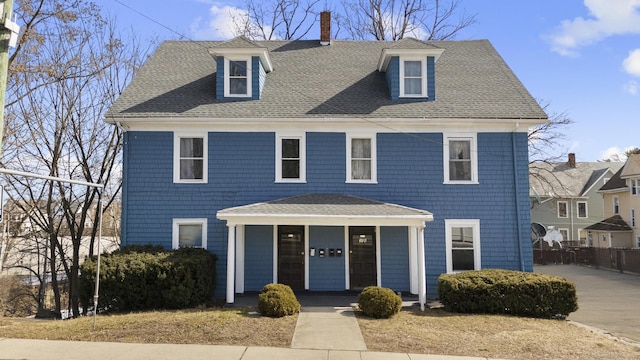 view of front of house featuring a shingled roof and a porch