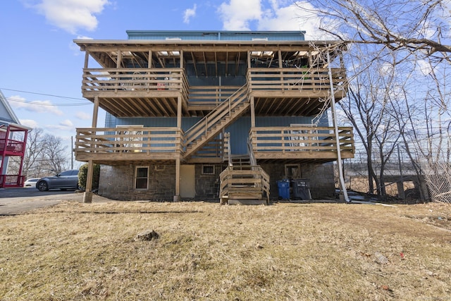 back of house with stairs and a wooden deck