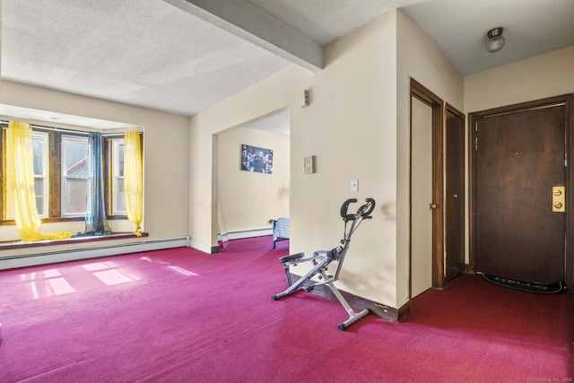 workout area featuring a baseboard heating unit, carpet flooring, a textured ceiling, and baseboards