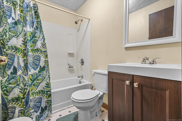 bathroom featuring a textured ceiling, shower / bath combo with shower curtain, vanity, and toilet