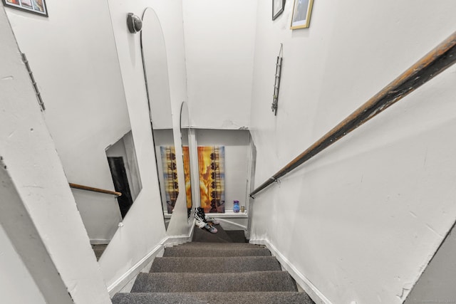 staircase featuring baseboards