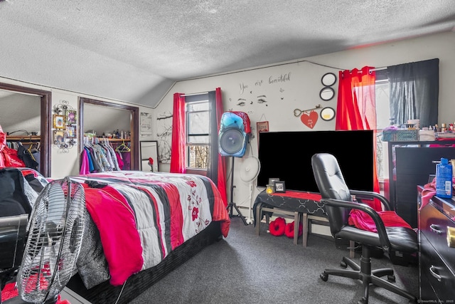 carpeted bedroom with lofted ceiling and a textured ceiling