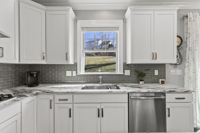 kitchen with appliances with stainless steel finishes, backsplash, a sink, and white cabinetry