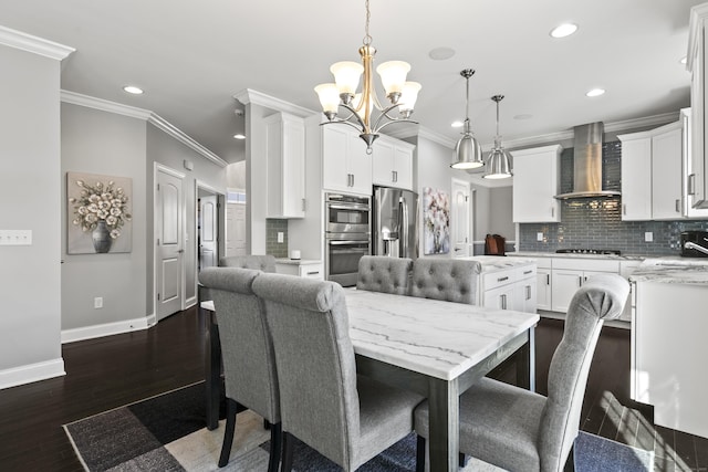 dining area with recessed lighting, dark wood-type flooring, baseboards, ornamental molding, and an inviting chandelier