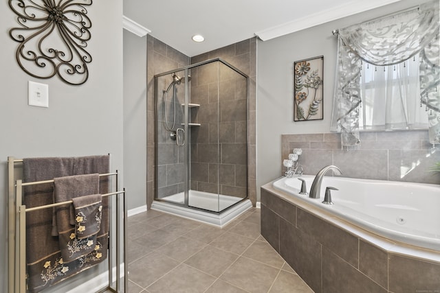 bathroom featuring a stall shower, tile patterned flooring, a bath, and crown molding