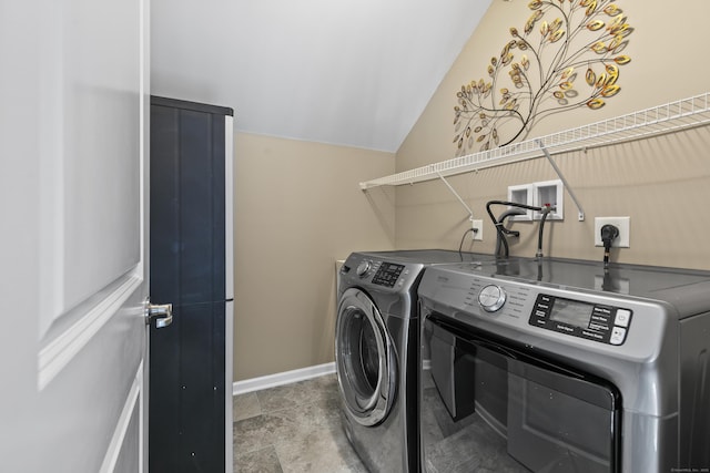 clothes washing area featuring laundry area, washing machine and dryer, and baseboards