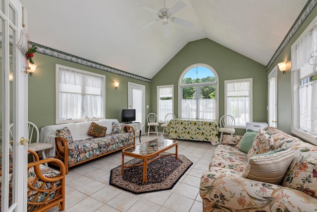 living area with light tile patterned flooring, vaulted ceiling, and ceiling fan