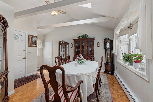 dining area featuring vaulted ceiling with skylight, a baseboard radiator, and baseboards