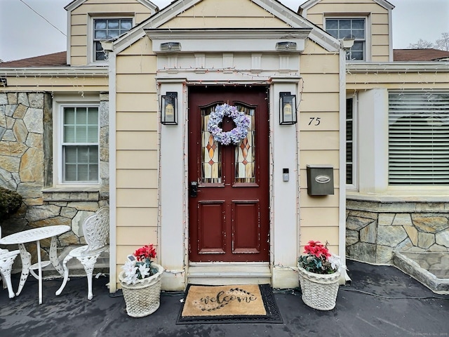 doorway to property featuring stone siding