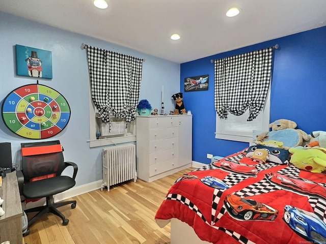 bedroom featuring recessed lighting, radiator, baseboards, and wood finished floors