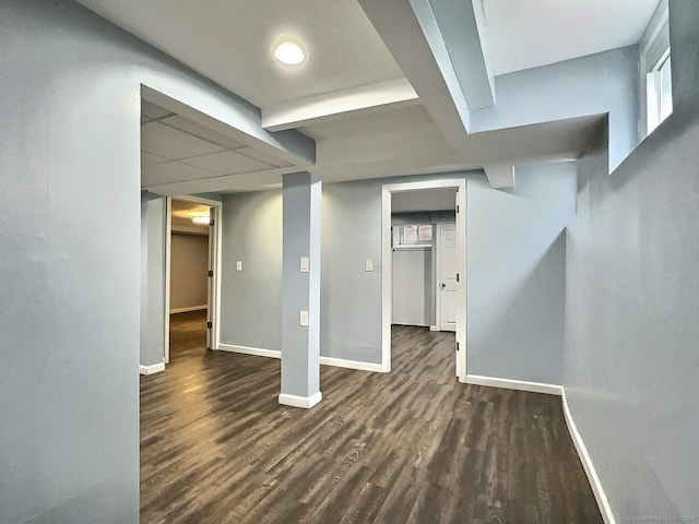 finished basement with dark wood-style flooring and baseboards