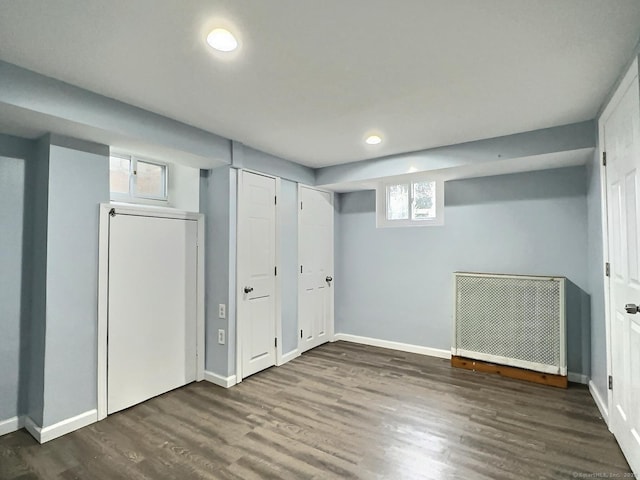 basement with recessed lighting, baseboards, and wood finished floors