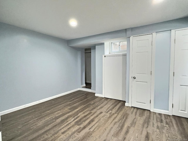 below grade area with baseboards and wood finished floors