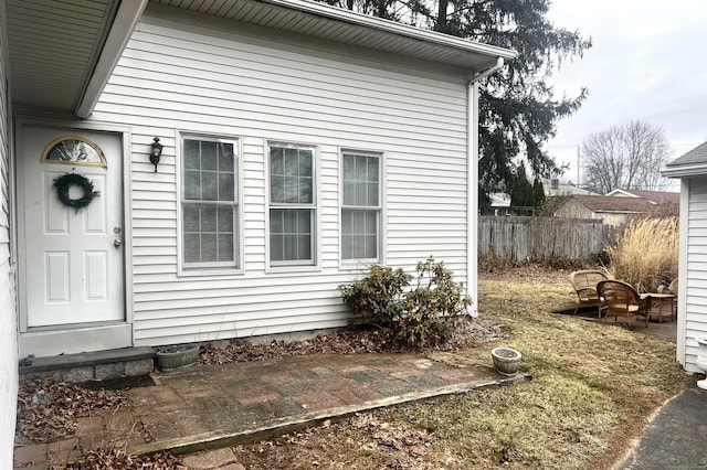 view of side of property with fence and a patio