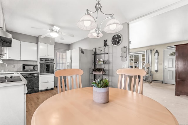 dining space featuring a baseboard radiator and a ceiling fan