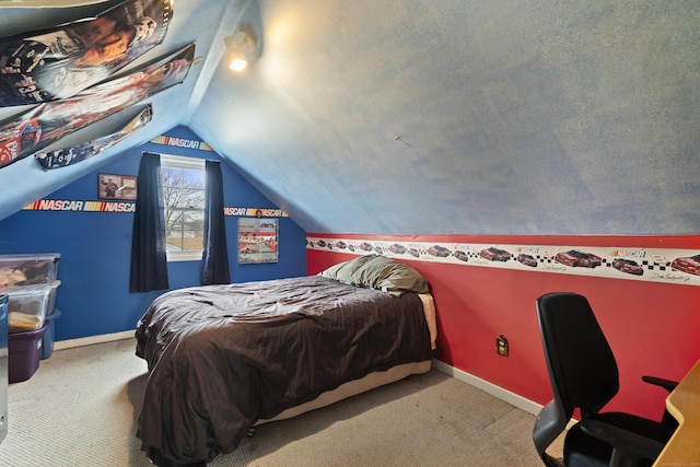 carpeted bedroom featuring vaulted ceiling and baseboards