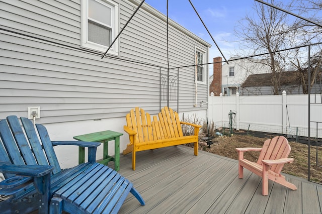 wooden terrace featuring fence