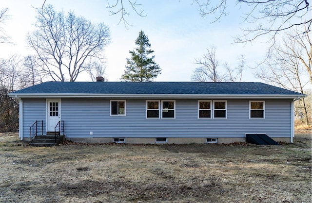 rear view of property featuring entry steps and a chimney