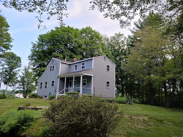 153 Bozrah St, Bozrah, CT 06334 - view of front of house with a porch, a front yard, and a chimney