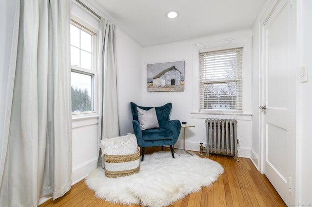 sitting room featuring recessed lighting, radiator, wood finished floors, and baseboards