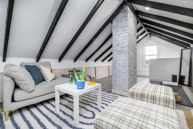 living area with lofted ceiling with beams and wood finished floors