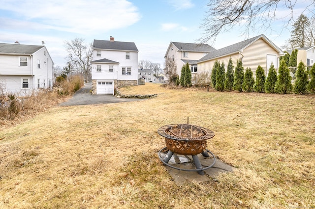 view of yard featuring an outdoor fire pit