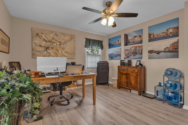 office area featuring light wood-style flooring, baseboards, and ceiling fan