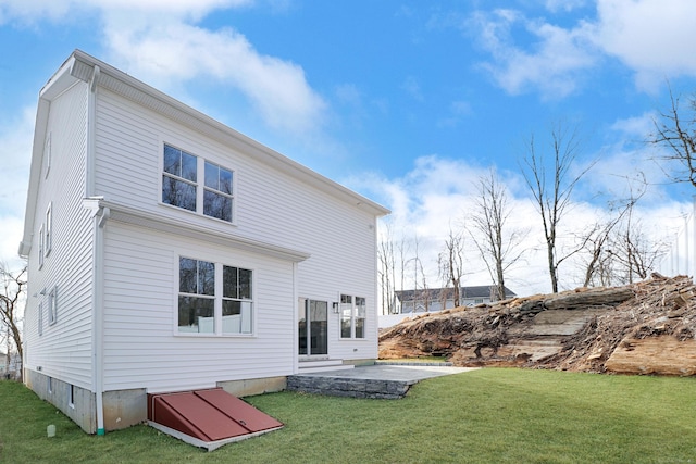 back of house featuring a lawn and a patio area