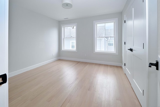 unfurnished room featuring light wood-style flooring and baseboards