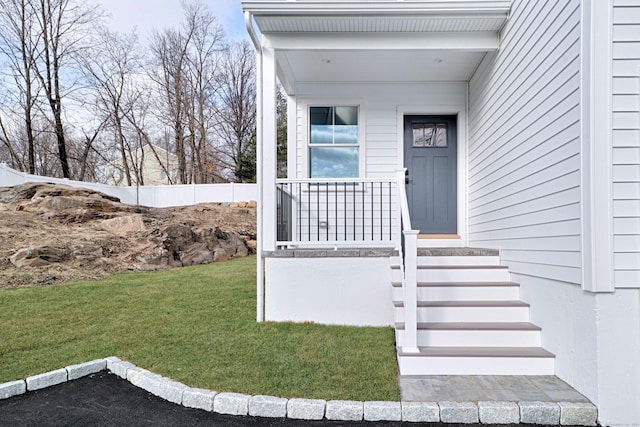 doorway to property featuring a yard