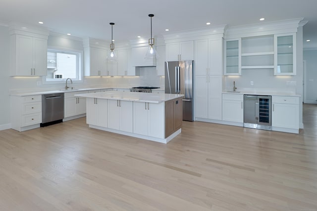 kitchen with wine cooler, stainless steel appliances, a sink, white cabinets, and open shelves