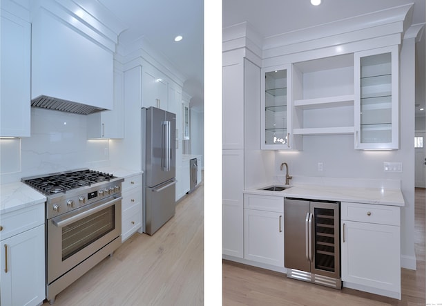 kitchen featuring wine cooler, light stone counters, a sink, appliances with stainless steel finishes, and open shelves