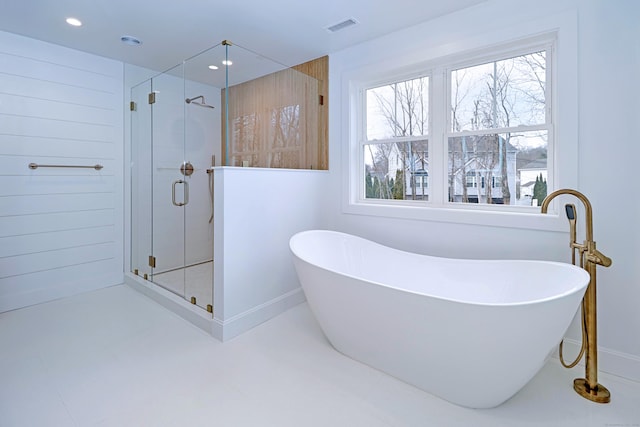 bathroom featuring visible vents, baseboards, a soaking tub, a shower stall, and recessed lighting