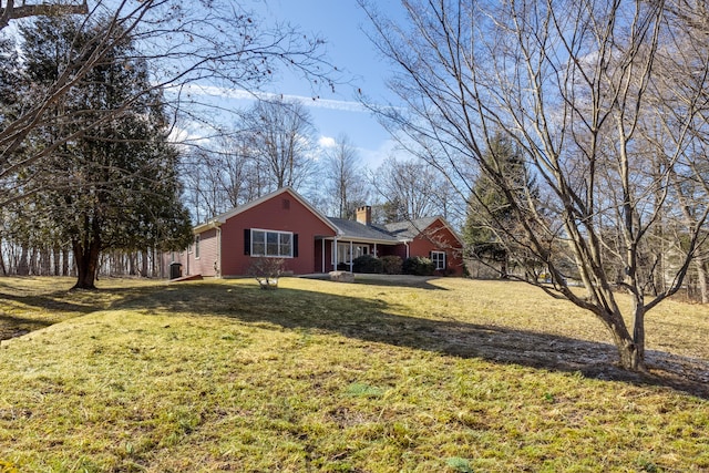 view of home's exterior with a lawn and a chimney