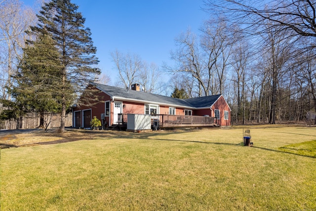 exterior space featuring a wooden deck, a chimney, and a yard