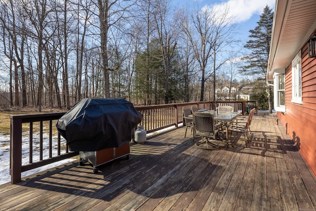 deck featuring outdoor dining space and area for grilling