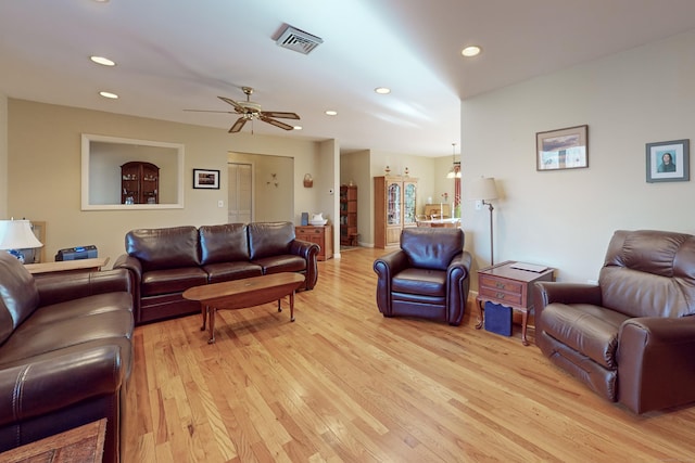 living room featuring ceiling fan, recessed lighting, visible vents, and light wood-style floors