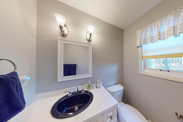 half bathroom with toilet and vanity