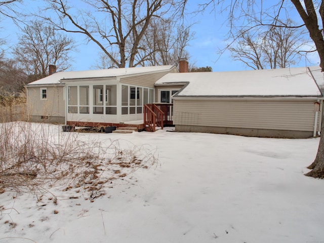 view of front of house featuring a sunroom and a chimney