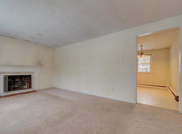 unfurnished living room with baseboards, tile patterned flooring, carpet flooring, a fireplace, and a chandelier