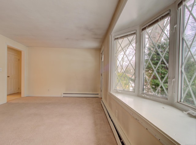 carpeted empty room featuring a baseboard heating unit