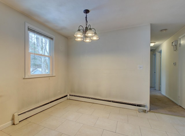 spare room with a baseboard heating unit and a notable chandelier