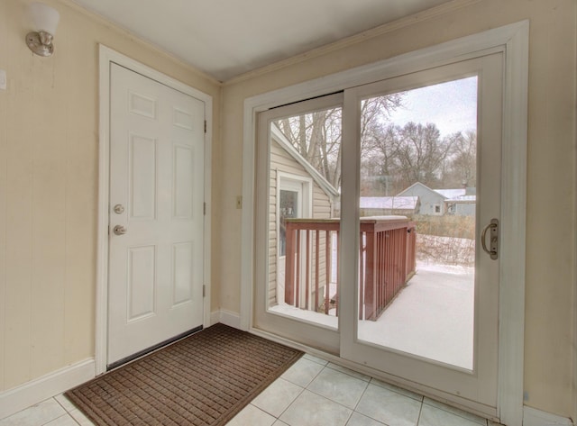 doorway with baseboards and light tile patterned floors