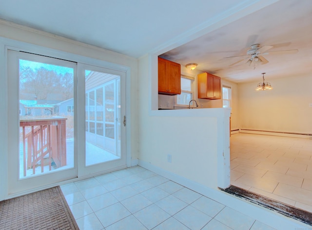 interior space featuring light tile patterned floors, a baseboard radiator, a sink, baseboards, and ceiling fan with notable chandelier